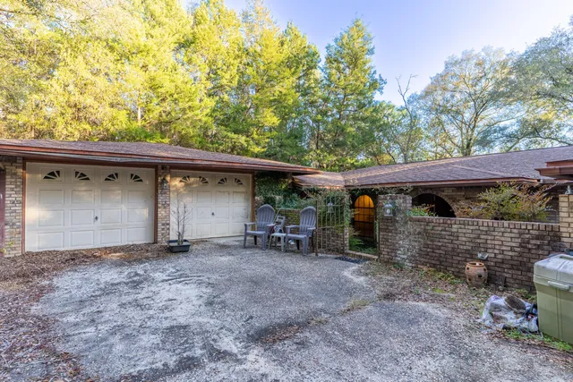 a view of a house with a backyard and a tree