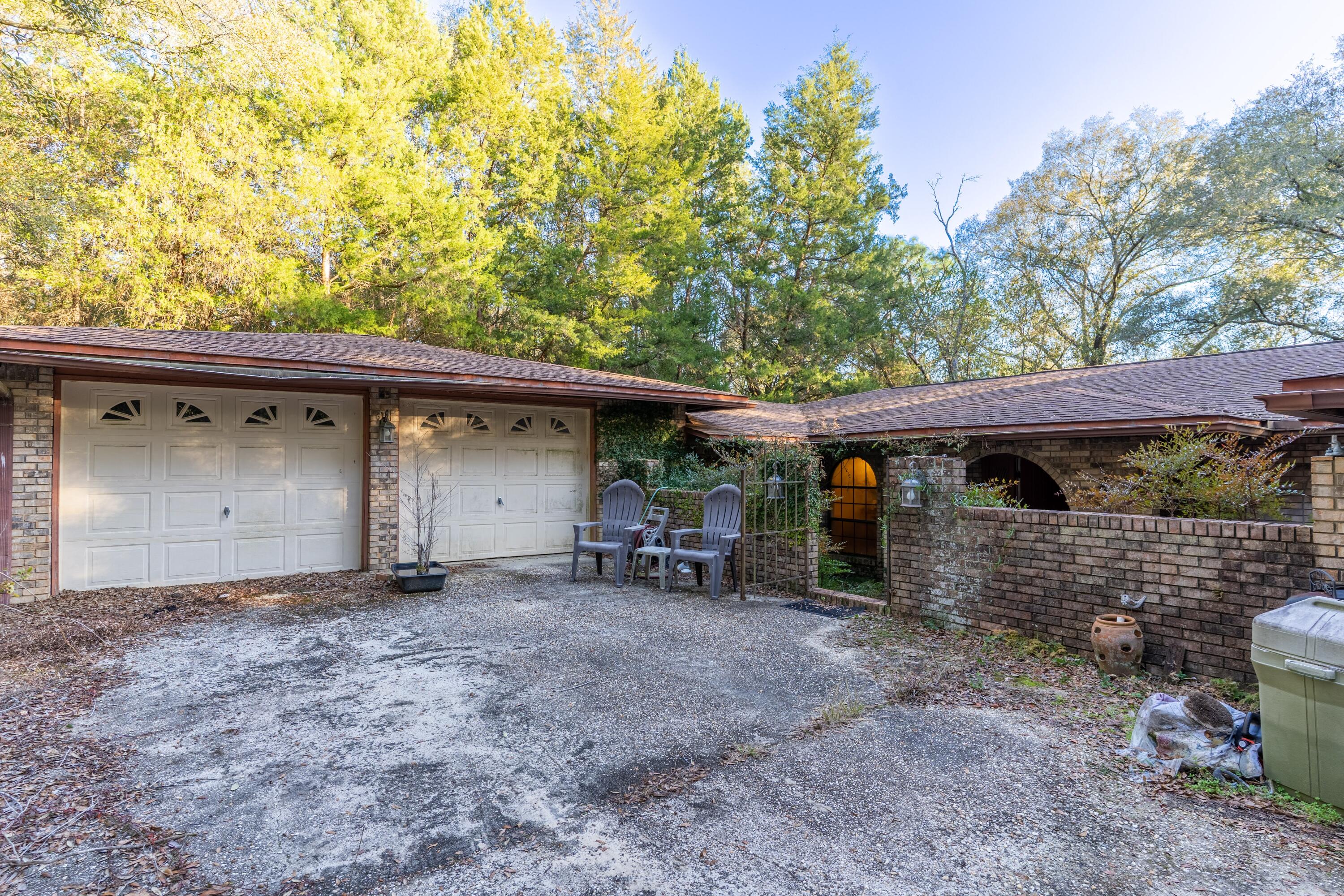 4444 Sundance Way Holt, FL 32564 - Photo 3 of 39 a view of a house with a backyard and a tree