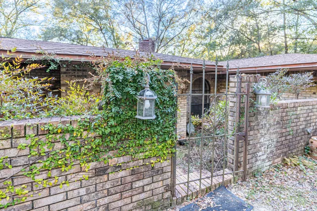 a backyard of a house with lots of green space and glass windows