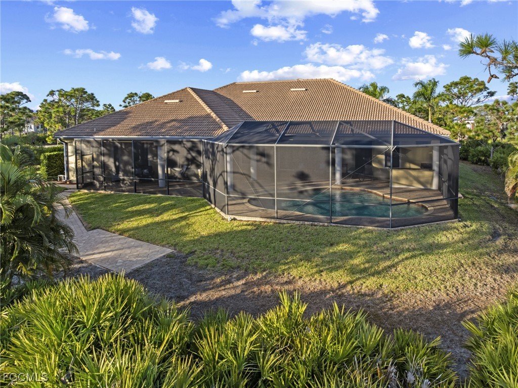 6057 Calusa Rdg Trail Bokeelia, FL 33922 - Photo 35 of 45 a view of a house with swimming pool and a yard