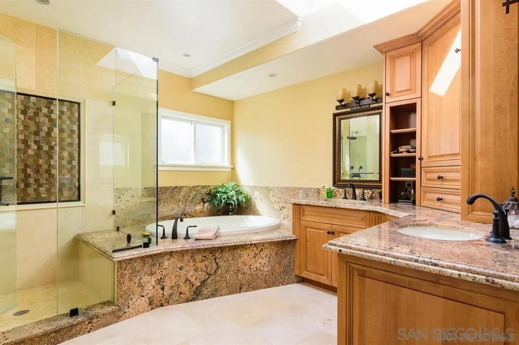 39 Green Turtle Road Coronado, CA 92118 - Photo 20 of 26 a spacious bathroom with a granite countertop tub sink and mirror