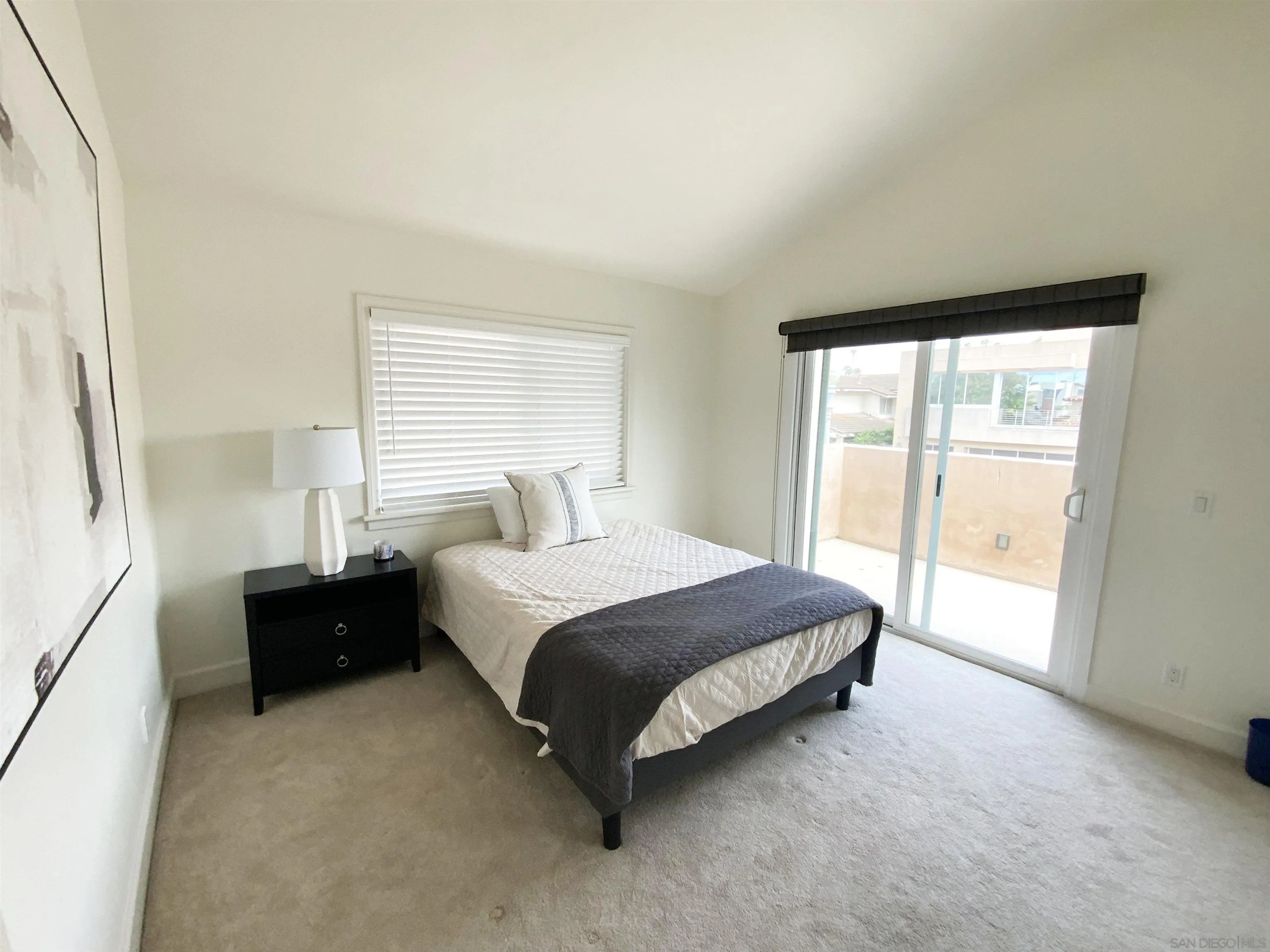 39 Green Turtle Road Coronado, CA 92118 - Photo 21 of 26 a spacious bedroom with a bed and a window