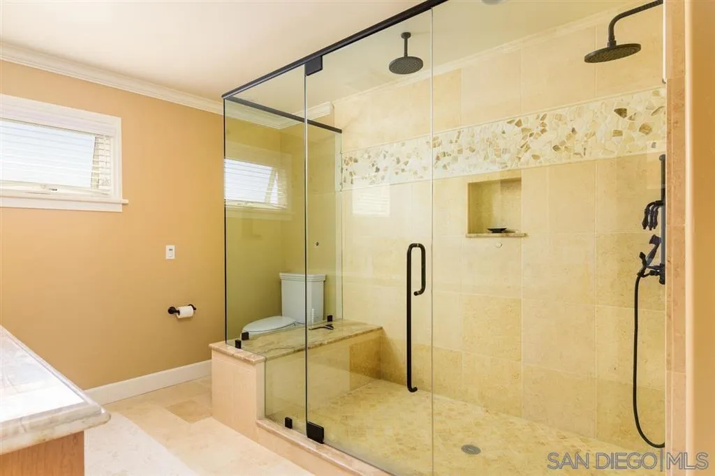 39 Green Turtle Road Coronado, CA 92118 - Photo 25 of 26 a bathroom with a tub shower and mirror