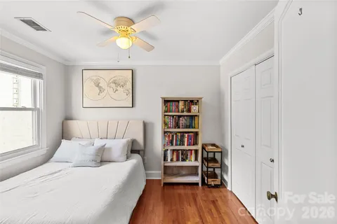 a bedroom with a bed and a book shelf