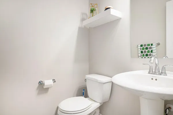 a white toilet sitting next to a bathroom sink