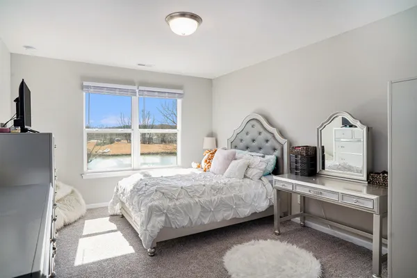 a bedroom with a bed and windows