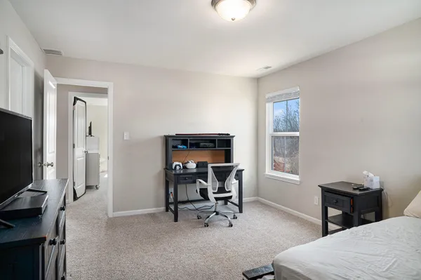 a view of a workspace with furniture and a window