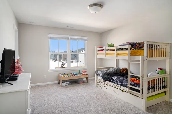 a room with baby crib and a window