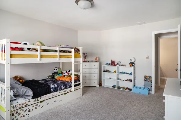 a bed room with a bed and a baby bed