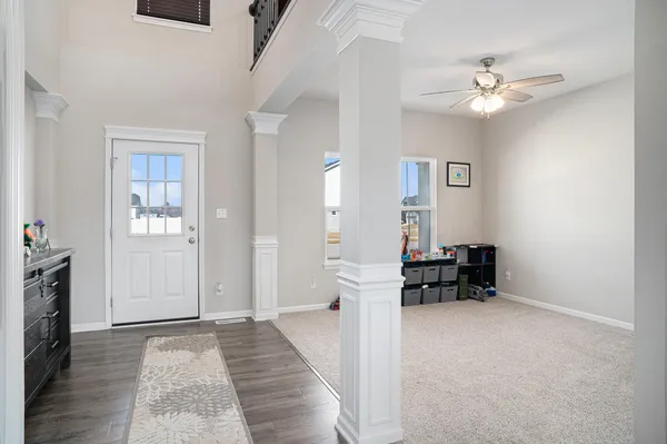 a view of an empty room with a fireplace and a chandelier