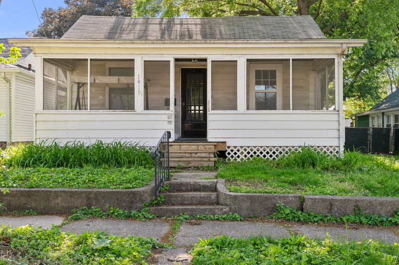 1419 17th Street Moline, IL 61265 - Photo 1 of 28 a front view of a house with a yard