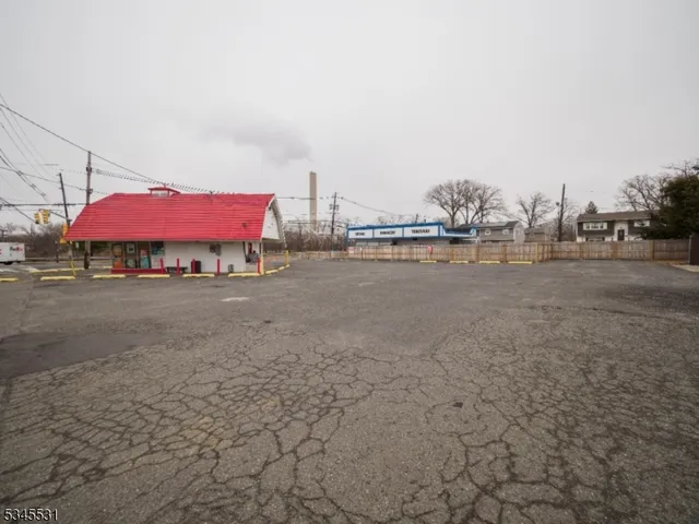 a backyard of a house with barbeque oven table and chairs