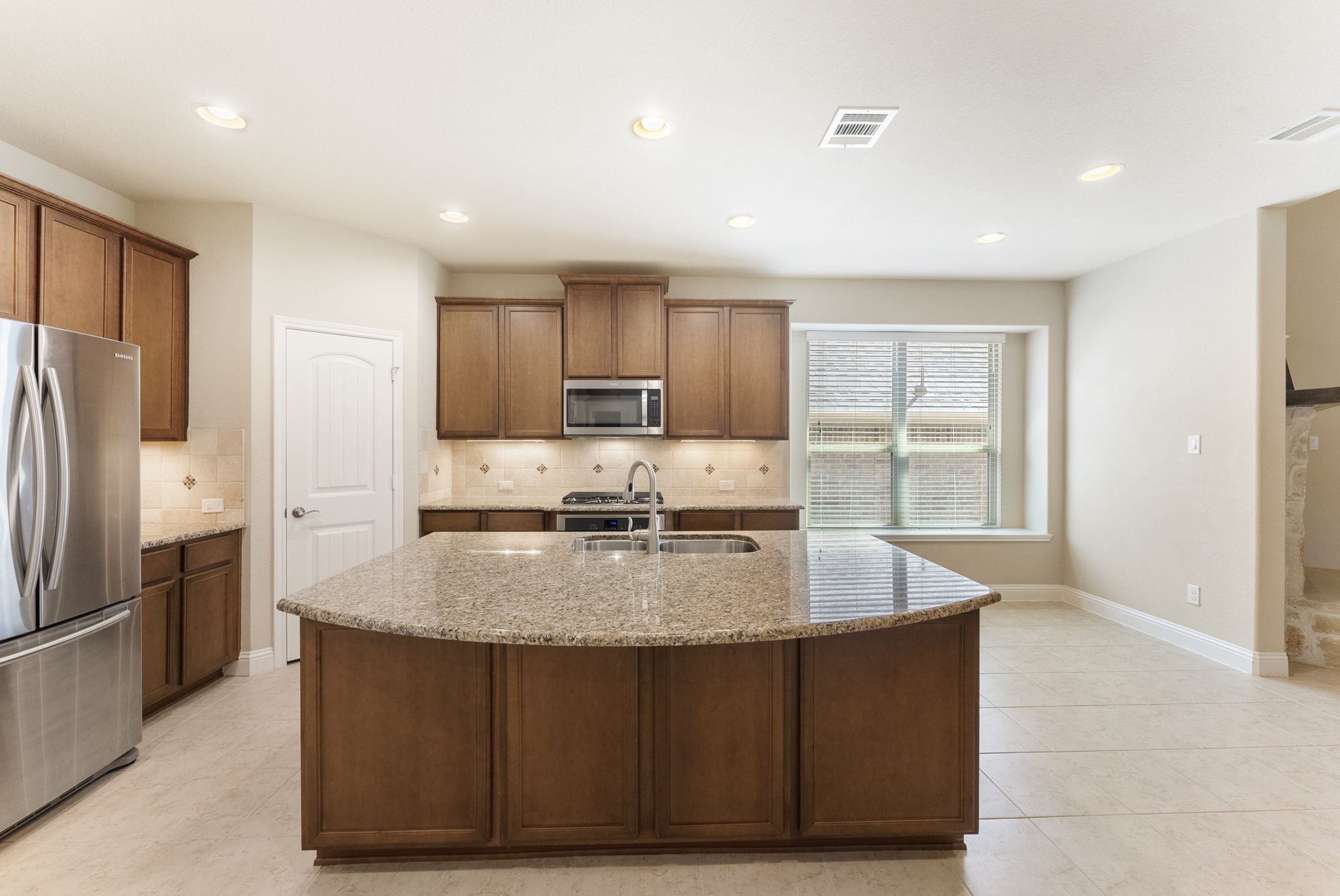 3565 Falcon Way Conroe, TX 77304 - Photo 10 of 50 Kitchen showcasing the granite island, cabinetry and stainless-steel appliances.