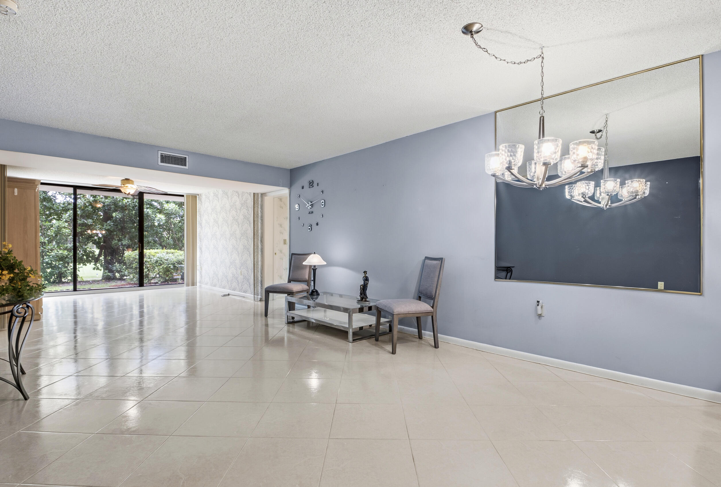 6145 Balboa Circle, Unit 103 Boca Raton, FL 33433 - Photo 11 of 31 a living room with furniture and a chandelier