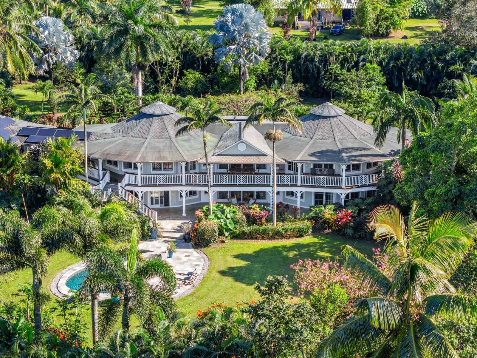 a view of house with yard and outdoor seating