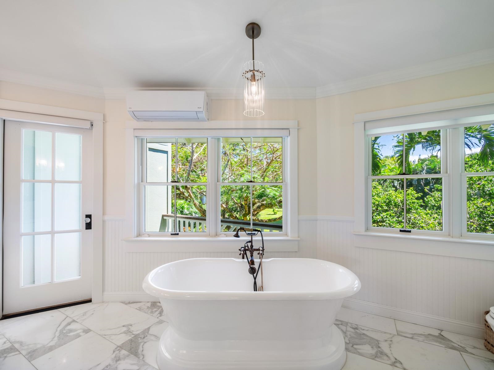 65 North Holokai Road Haiku, HI 96708 - Photo 38 of 50 a white bath tub sitting in a bathroom next to a window