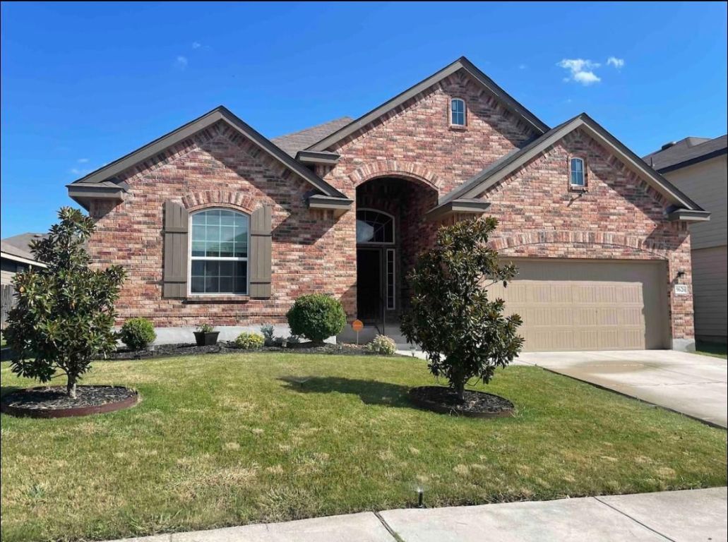 a front view of a house with a yard