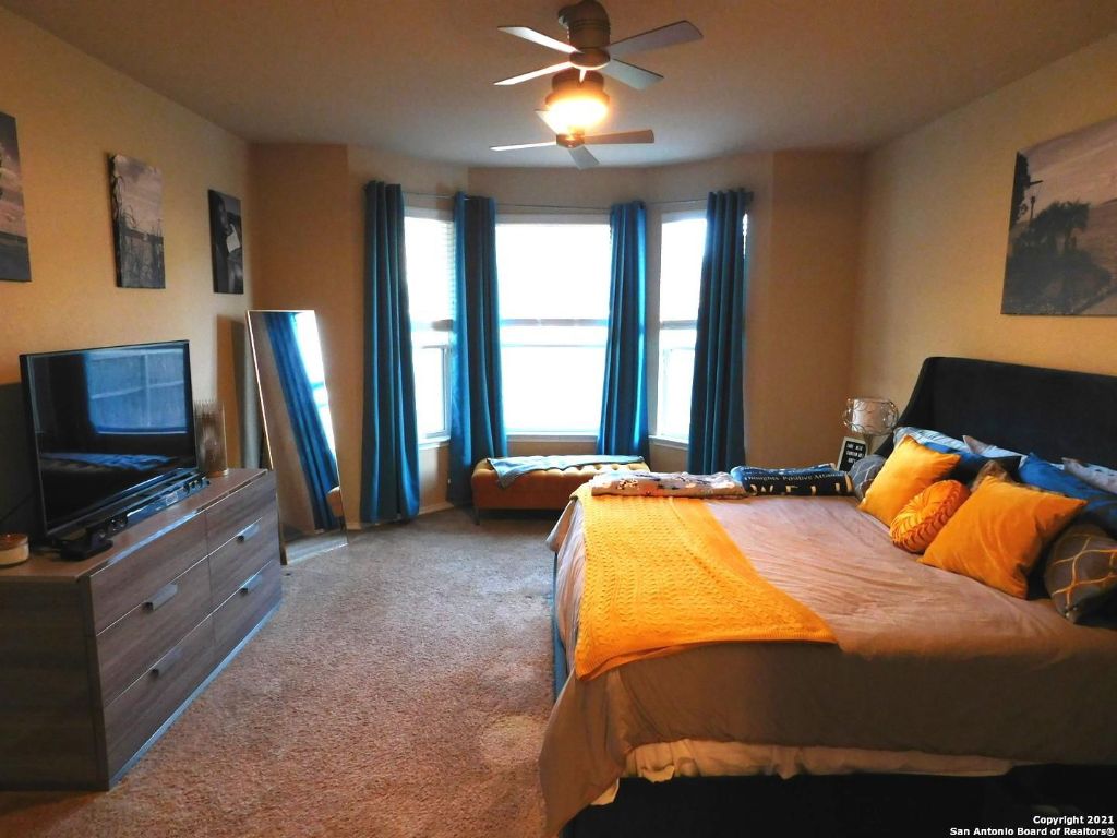 9626 Common Law Converse, TX 78109 - Photo 11 of 31 a bedroom with a bed and a flat screen tv