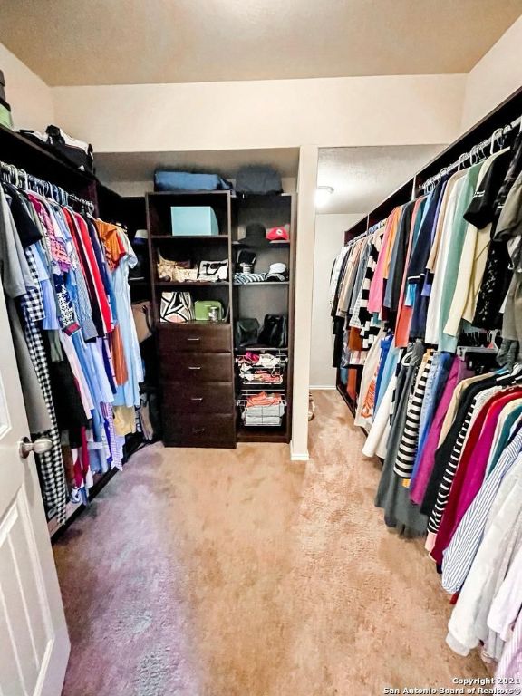 9626 Common Law Converse, TX 78109 - Photo 14 of 31 a view of walk in closet with clothes and shoes