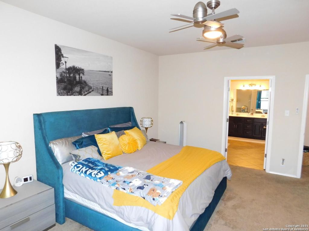 9626 Common Law Converse, TX 78109 - Photo 25 of 31 a bedroom with a bed and wooden floor