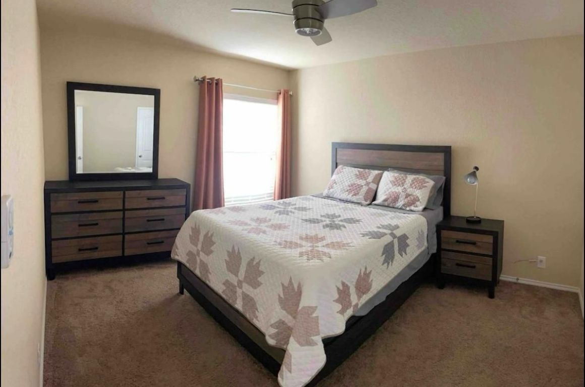 9626 Common Law Converse, TX 78109 - Photo 27 of 31 a large bed sitting in a bedroom next to a window and dresser