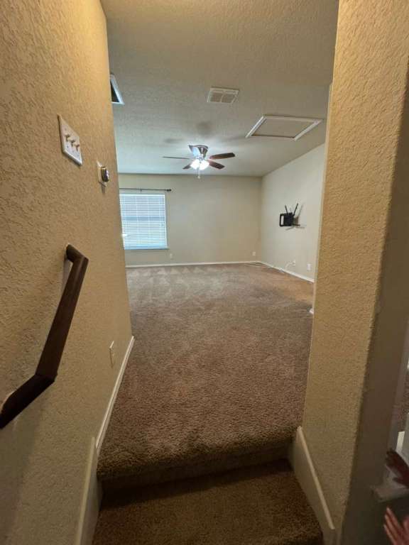 9626 Common Law Converse, TX 78109 - Photo 28 of 31 Carpeted spare room with a textured wall, ceiling fan, and a textured ceiling