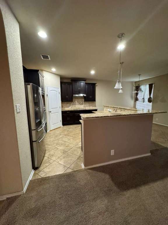 9626 Common Law Converse, TX 78109 - Photo 4 of 31 a kitchen with stainless steel appliances granite countertop a refrigerator sink and microwave