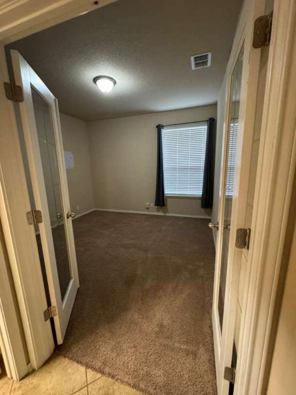 9626 Common Law Converse, TX 78109 - Photo 9 of 31 Spare room featuring light colored carpet and a textured ceiling