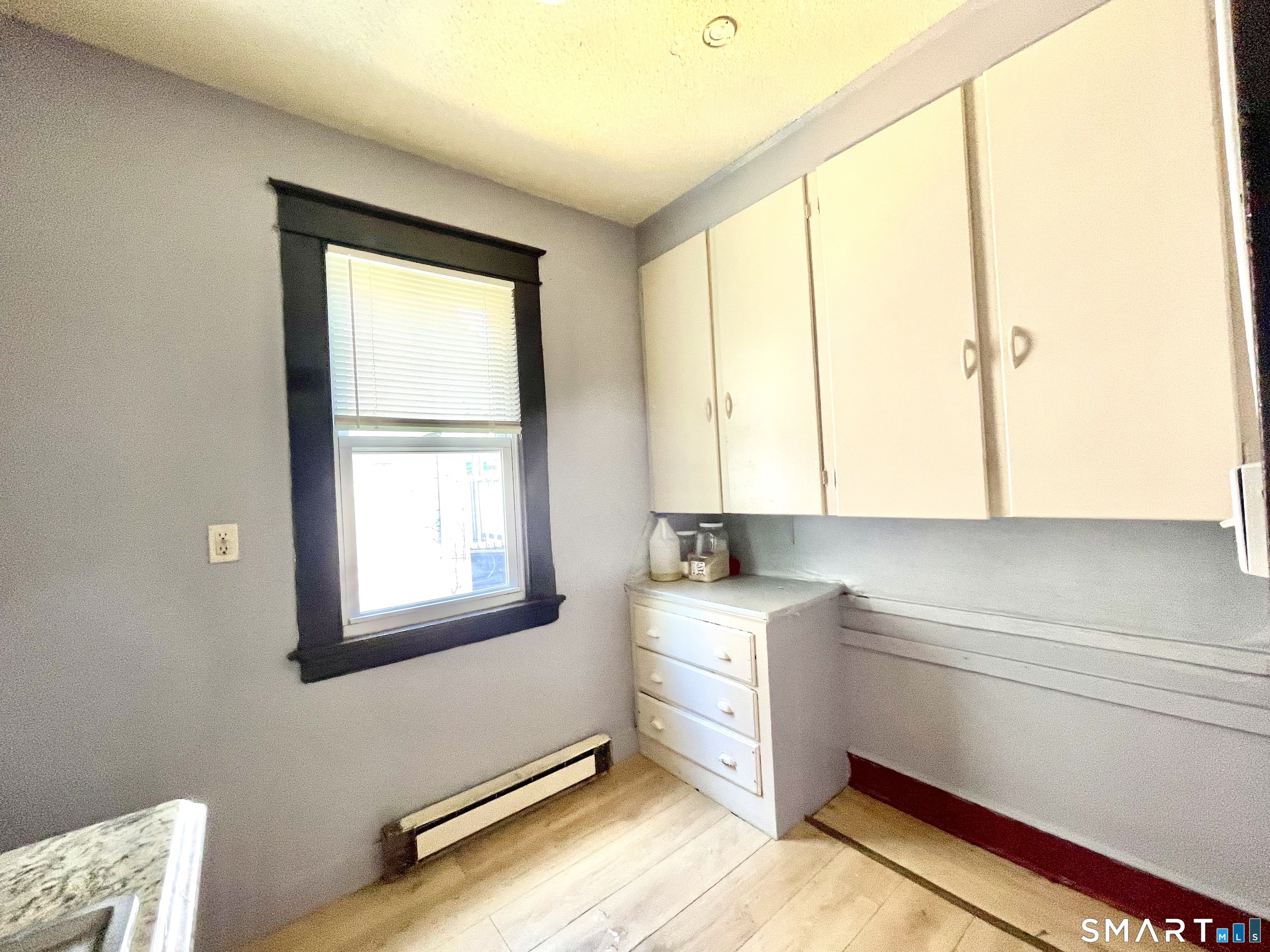 146 Charles Street, Unit 3 Waterbury, CT 06708 - Photo 11 of 20 a room with a window bed and cabinets