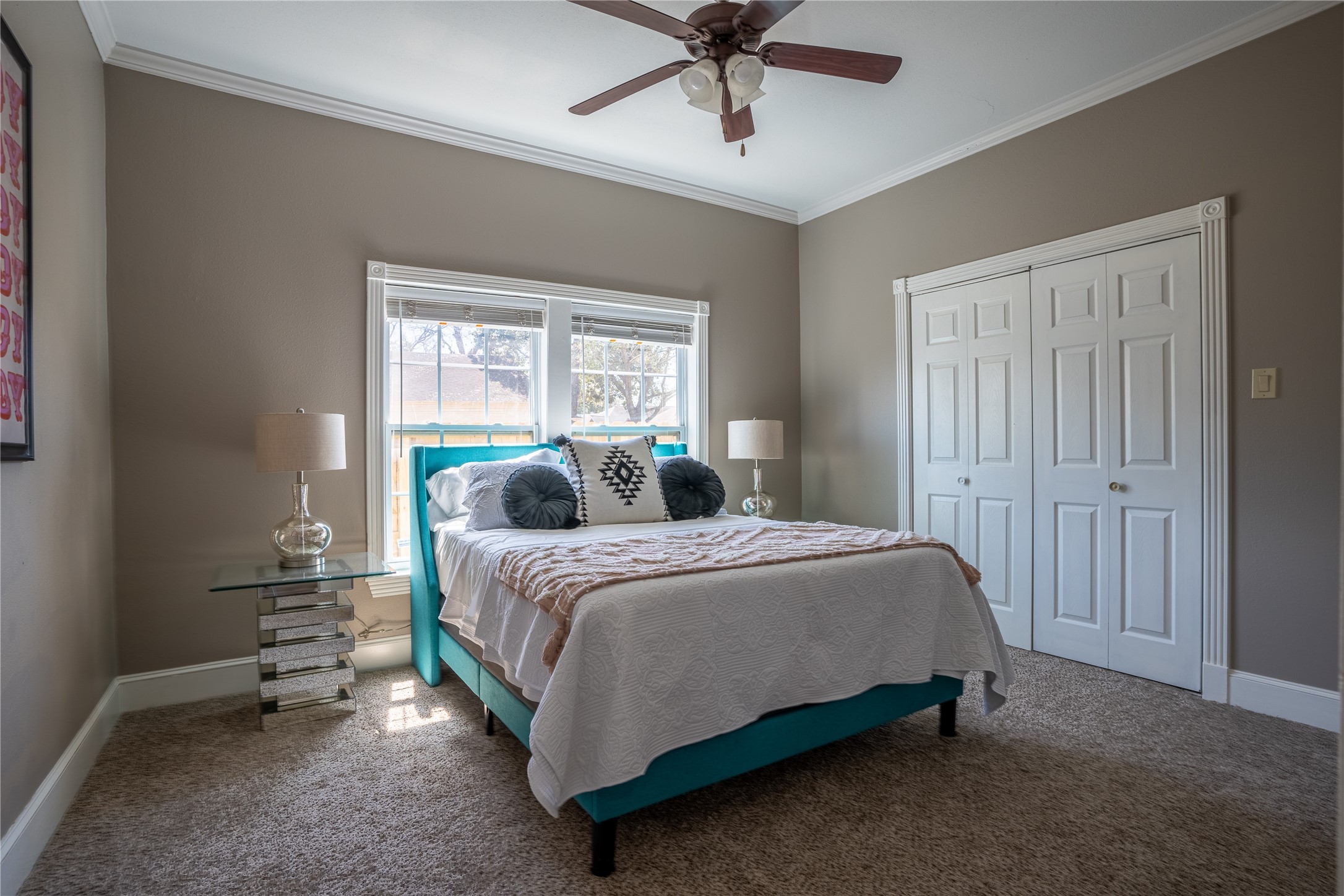 802 Enid Street Houston, TX 77009 - Photo 11 of 18 a bedroom with a bed and a chandelier