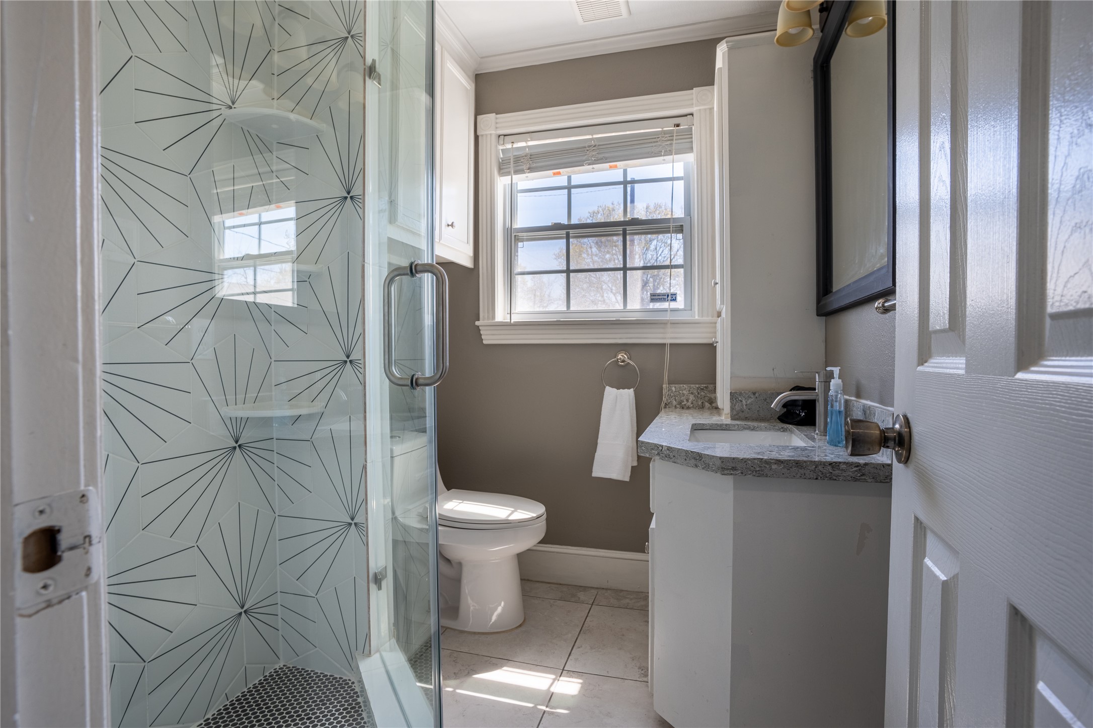 802 Enid Street Houston, TX 77009 - Photo 13 of 18 a bathroom with a granite countertop sink toilet and shower
