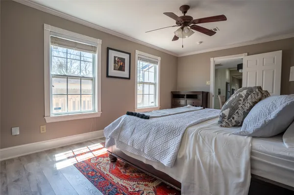 a bedroom with a bed and a chandelier