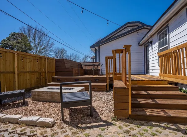 a backyard of a house with barbeque oven table and chairs