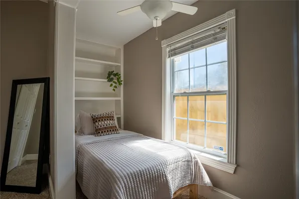 a bedroom with a bed and a window