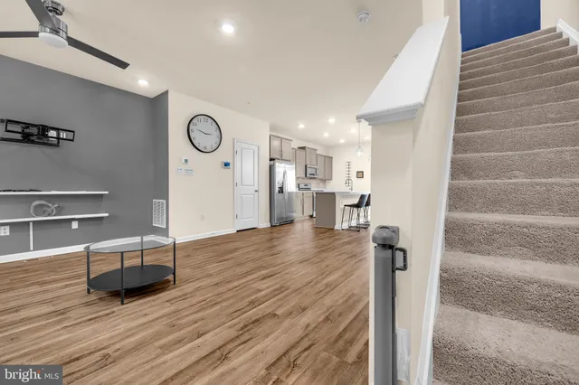 a view of a living room and kitchen with wooden floor