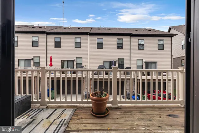 a view of a patio with couches and wooden floor