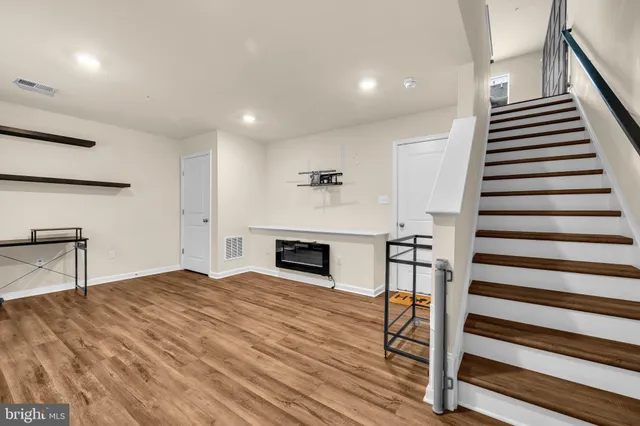 a view of a livingroom with furniture and staircase