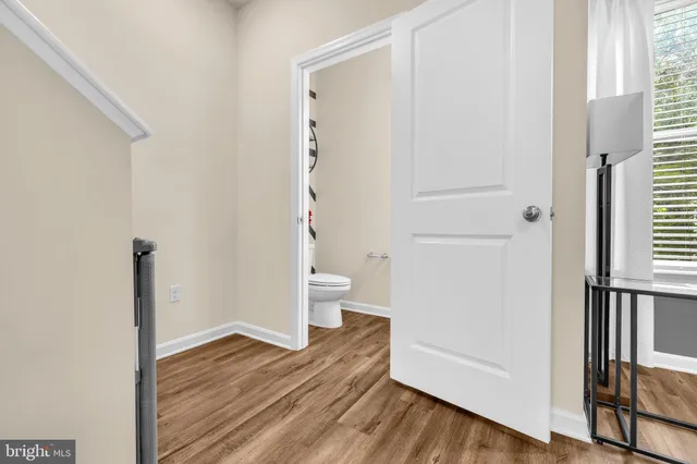 a view of bathroom with a toilet and a window