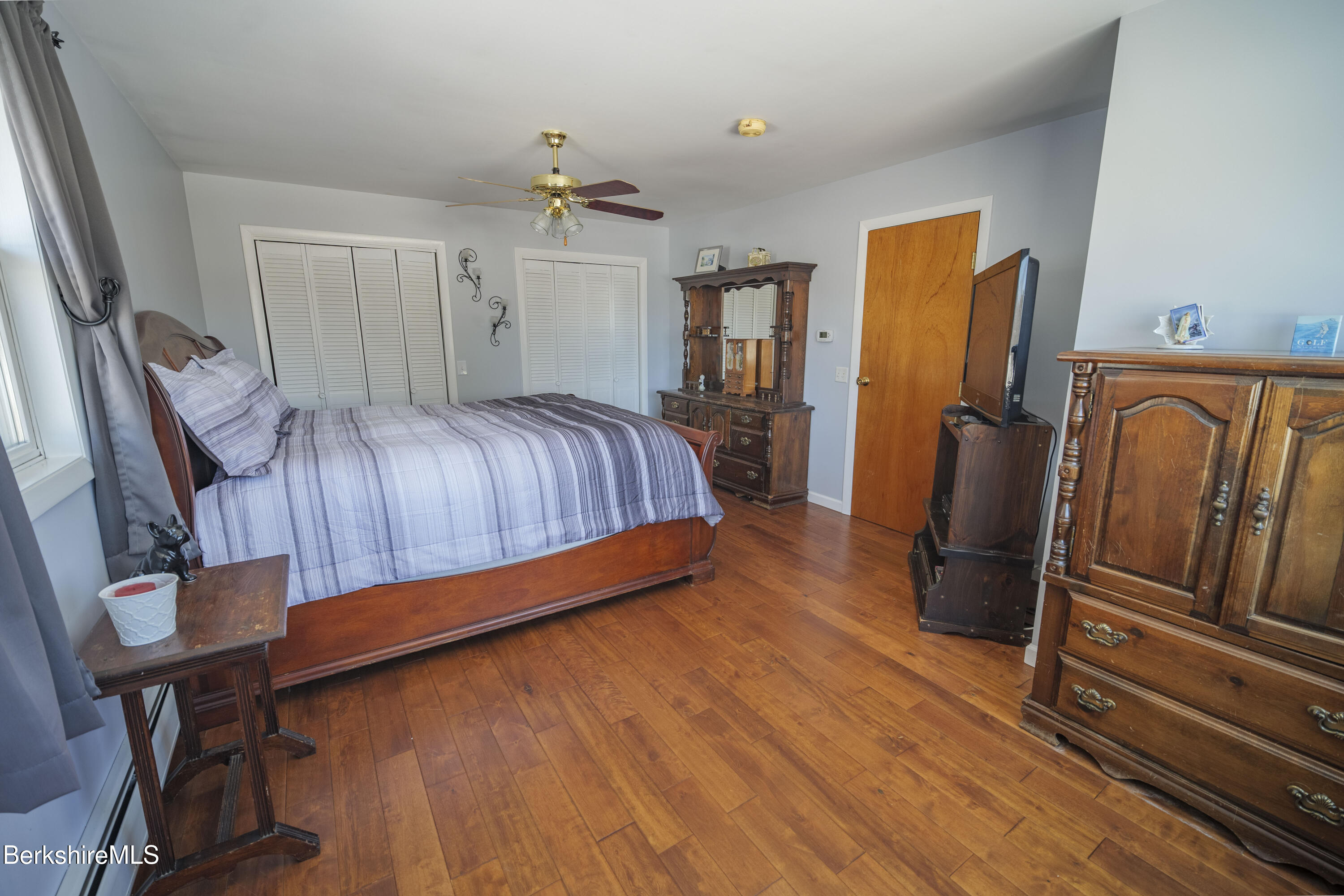 582 East New Lenox Road Pittsfield, MA 01201 - Photo 13 of 23 a bedroom with a bed and wooden floor