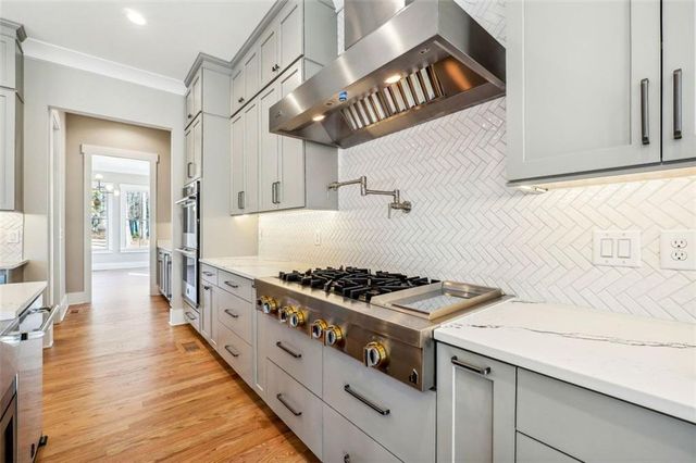 a view of empty room with wooden floor and windows