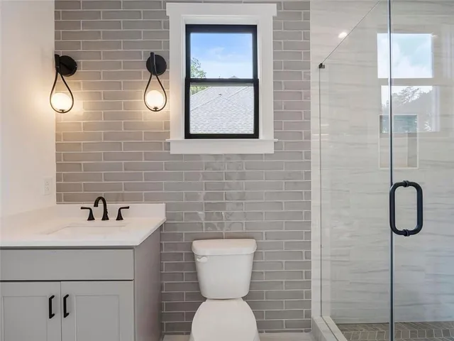 a kitchen with a sink a refrigerator and cabinets
