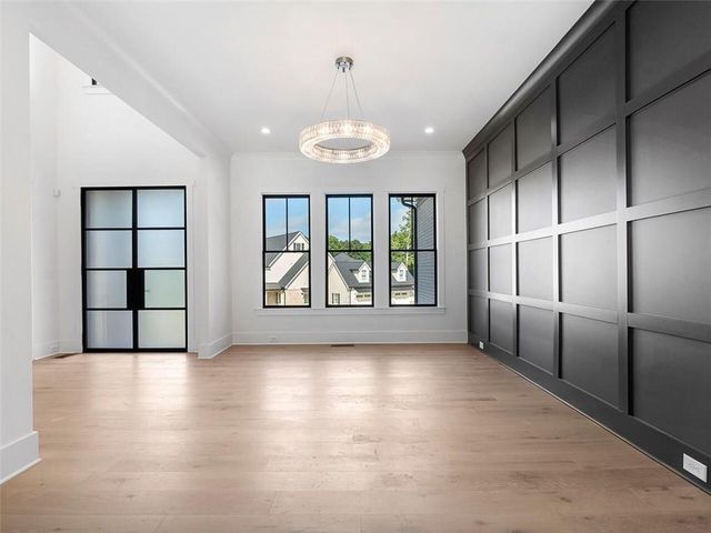 a view of an empty room with glass door and balcony
