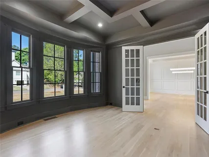 a large kitchen with stainless steel appliances kitchen island granite countertop a stove a sink and a living room view