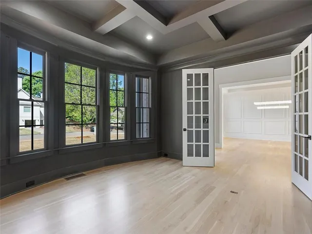 a large kitchen with stainless steel appliances kitchen island granite countertop a stove a sink and a living room view