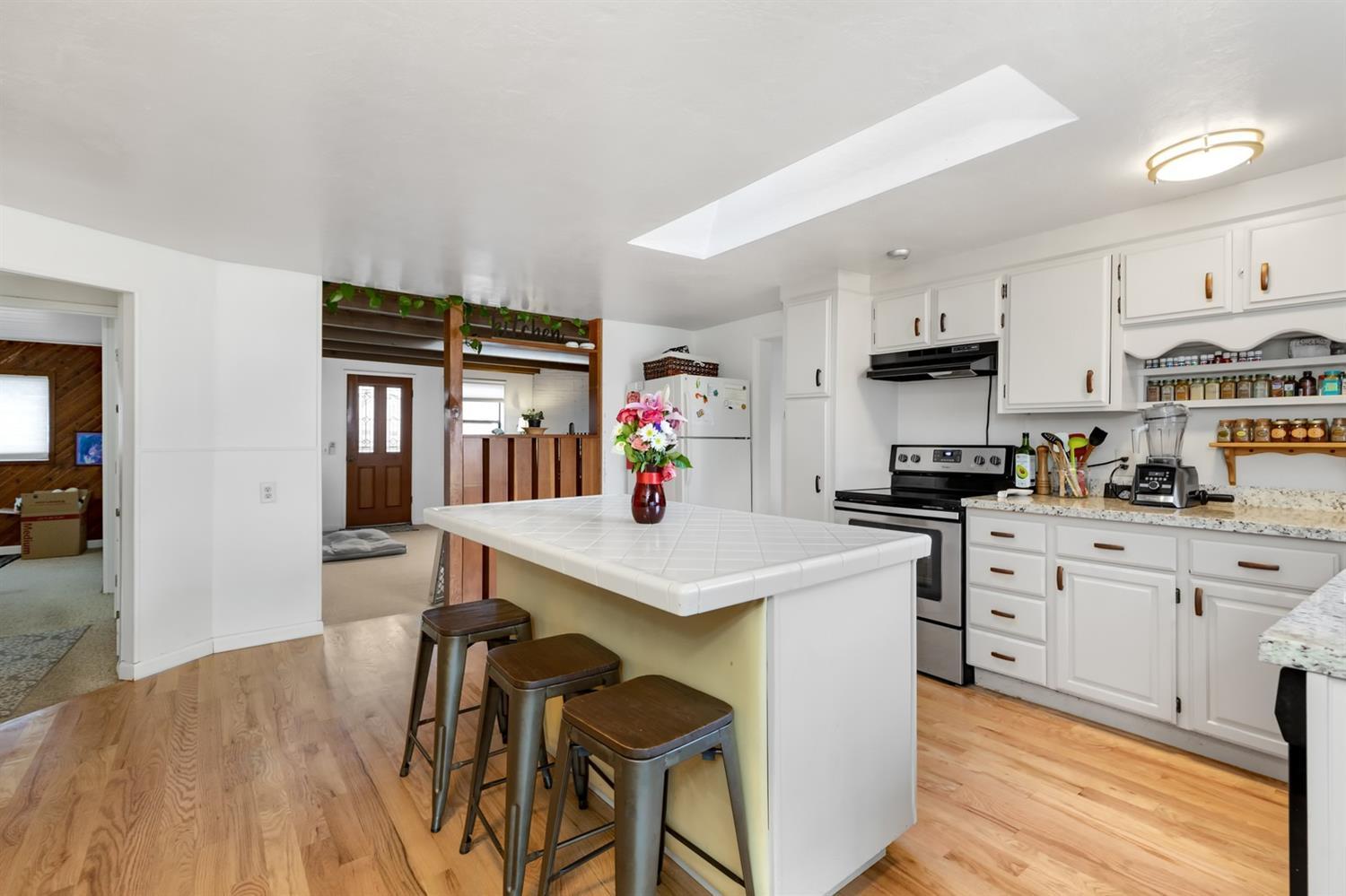 404 Wilson Road Ashland, OR 97520 - Photo 21 of 34 a kitchen that has a lot of white cabinets and wooden floor
