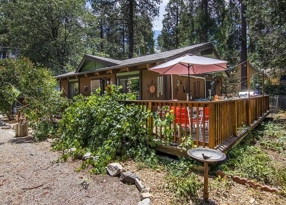 52845 Pine Cove Road Idyllwild, CA 92549 - Photo 1 of 15 a view of a small house with yard and sitting area