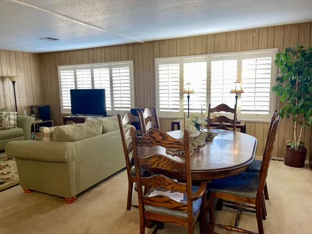 a living room with furniture ceiling fan and a window