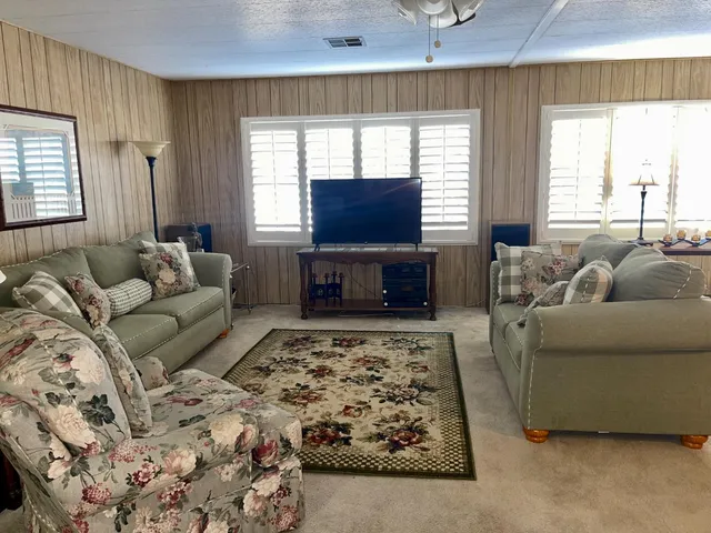 a kitchen with stainless steel appliances granite countertop a sink dishwasher stove and cabinets with wooden floor