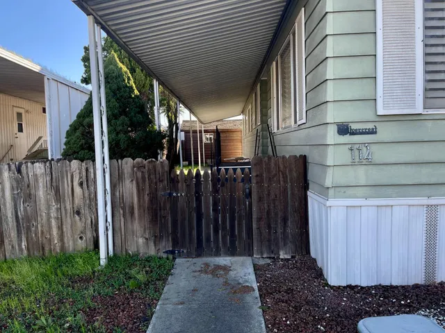 a view of a house with a wooden fence