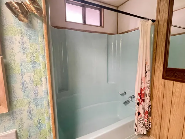 a bathroom with a glass shower door
